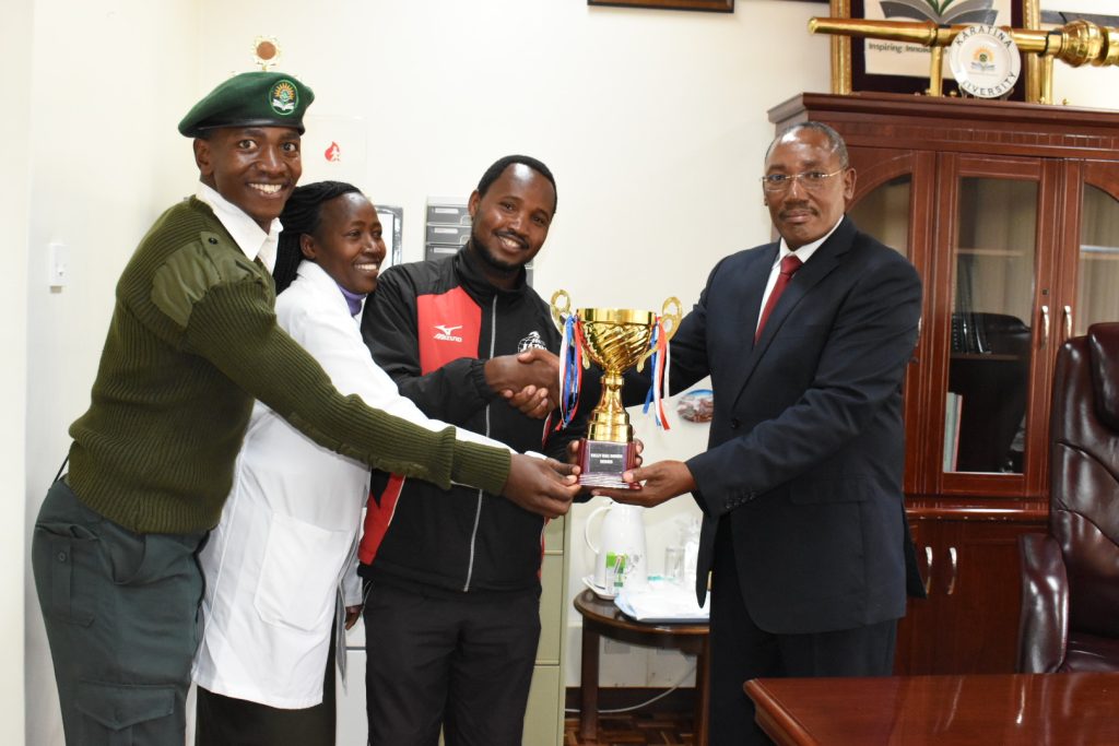 ACTING VICE CHANCELLOR RECEIVES TROPHIES WON DURING THE KUSA CENTRAL STAFF GAMES
