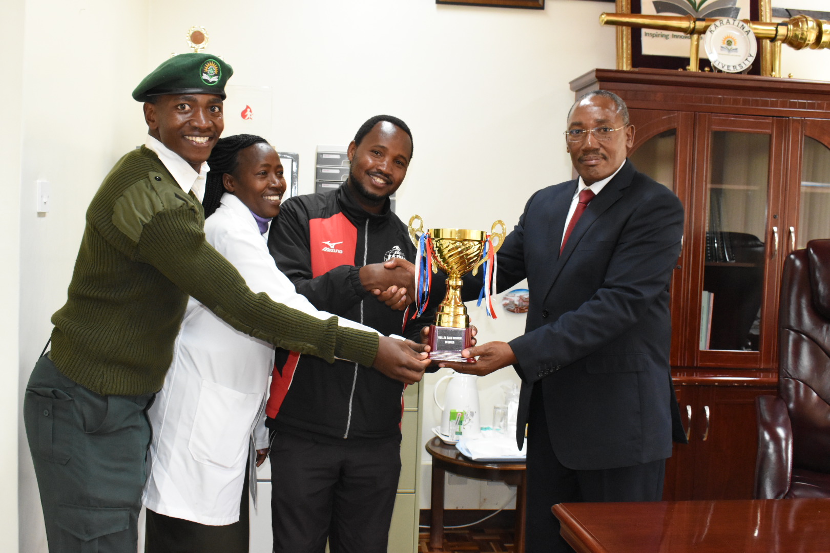 ACTING VICE CHANCELLOR RECEIVES TROPHIES WON DURING THE KUSA CENTRAL STAFF GAMES